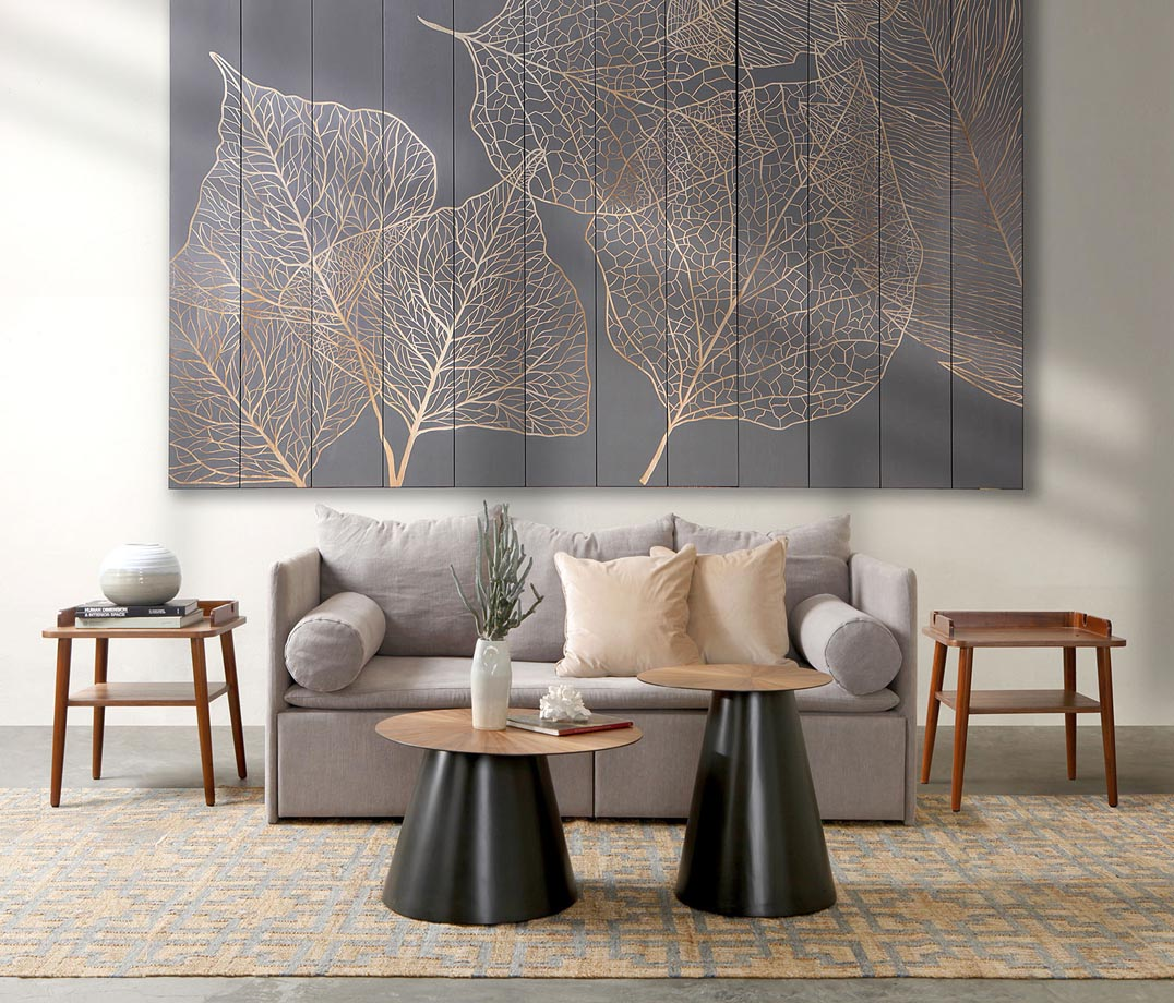 Triboa Bay Living interior — styled sofa, side tables, and gold leaf wall art